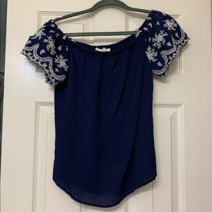 Blue off the shoulder shirt.